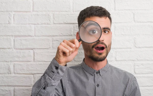 Young Adult Man Brick Wall Using Magnifying Glass Scared Shock — Stock Photo, Image