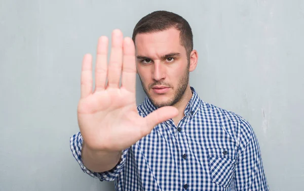 Young Caucasian Man Grey Grunge Wall Open Hand Doing Stop — Stock Photo, Image