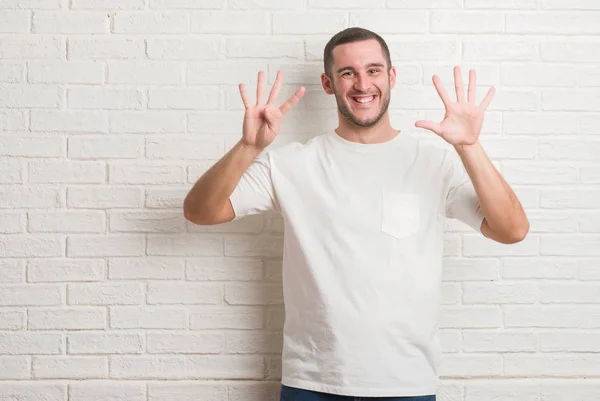 Joven Hombre Caucásico Pie Sobre Pared Ladrillo Blanco Que Muestra —  Fotos de Stock