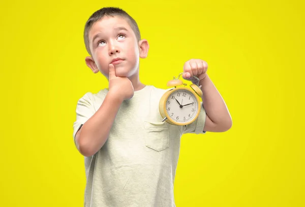 Little Child Holding Alarm Clock Serious Face Thinking Question Very — Stock Photo, Image