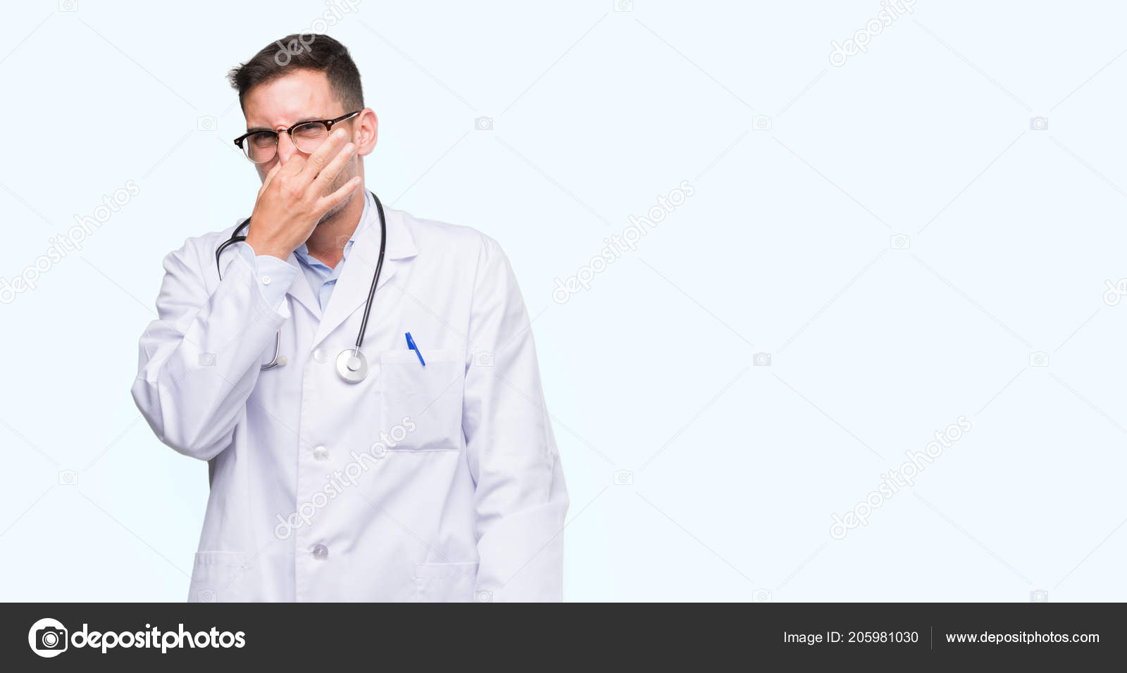 Handsome Young Doctor Man Smelling Something Stinky Disgusting Intolerable  Smell — Stock Photo © Krakenimages.com #205981030, image size:1600x956