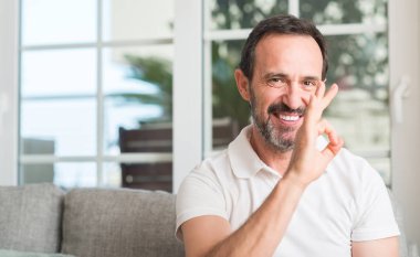 Parmak, mükemmel sembolü ile ok işareti yapan yakışıklı orta yaş erkek