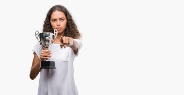 Kamera ve size, el işareti, pozitif ve kendinden emin bir jest ön parmak ile işaret genç İspanyol kadın holding kupa