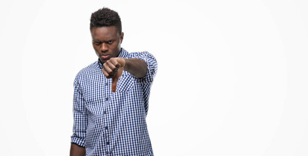 Young african american man wearing blue shirt looking unhappy and angry showing rejection and negative with thumbs down gesture. Bad expression.