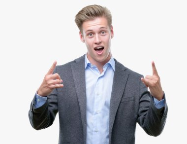 Genç yakışıklı sarışın iş adamı deli ifade rock simge elle yapıyor ile bağırarak. Müzik yıldızı. Ağır kavramı.