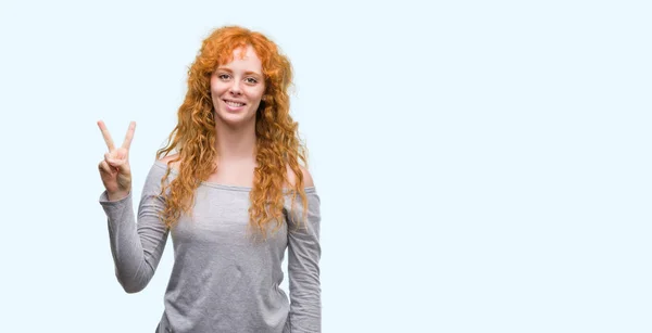 Young Redhead Woman Showing Pointing Fingers Number Two While Smiling — Stock Photo, Image