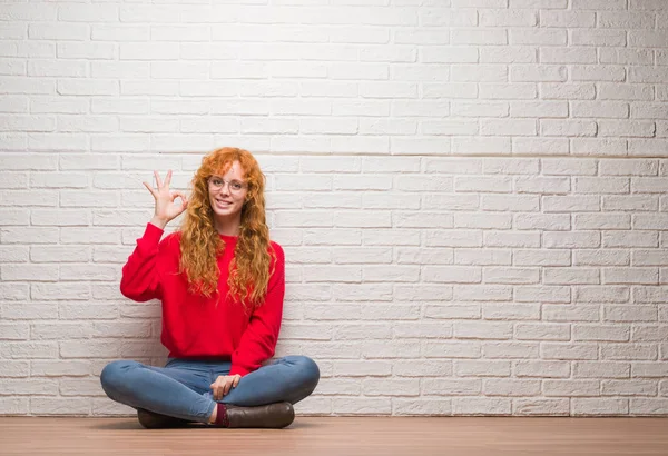 Mulher Ruiva Jovem Sentado Sobre Parede Tijolo Sorrindo Positivo Fazendo — Fotografia de Stock