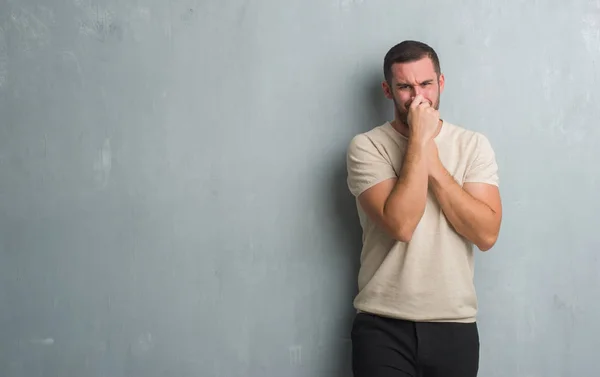 Hombre Caucásico Joven Sobre Pared Gris Grunge Oliendo Algo Apestoso — Foto de Stock