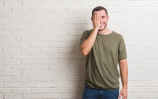 Young Caucasian Man Standing White Brick Wall Covering One Eye — Stock Photo, Image
