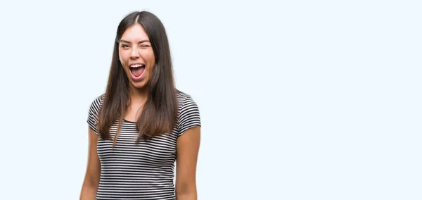 Young beautiful hispanic woman winking looking at the camera with sexy expression, cheerful and happy face. — Stock Image Young Beautiful Hispanic Woman Winking Looking Camera Sexy Expression Cheerful Stock Image