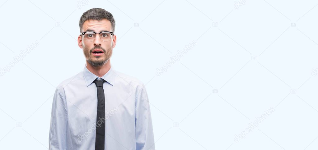 Young business man scared in shock with a surprise face, afraid and excited with fear expression