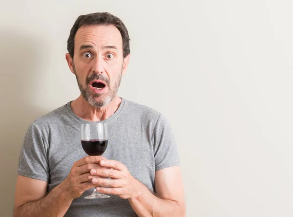 Senior Man Drinking Red Wine Glass Scared Shock Surprise Face — Stock Photo, Image