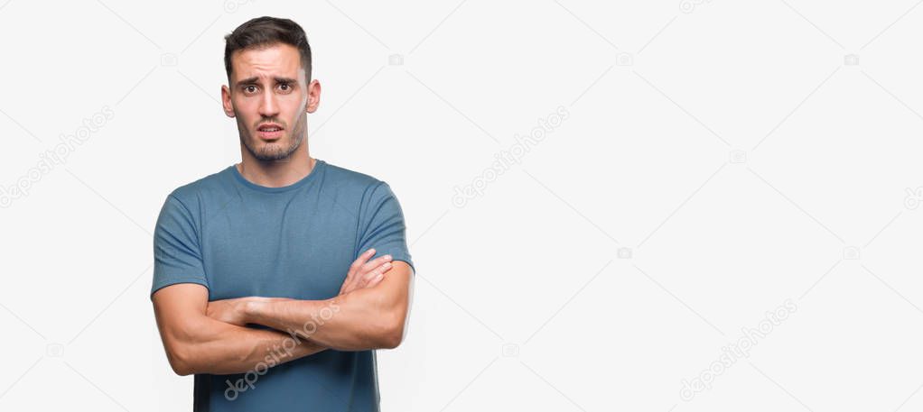Handsome young casual man skeptic and nervous, disapproving expression on face with crossed arms. Negative person.