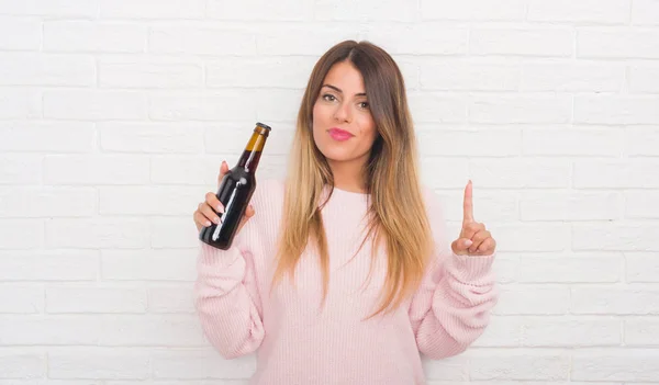 Mujer Adulta Yound Sobre Pared Ladrillo Blanco Sosteniendo Cerveza Sorprendida — Foto de Stock