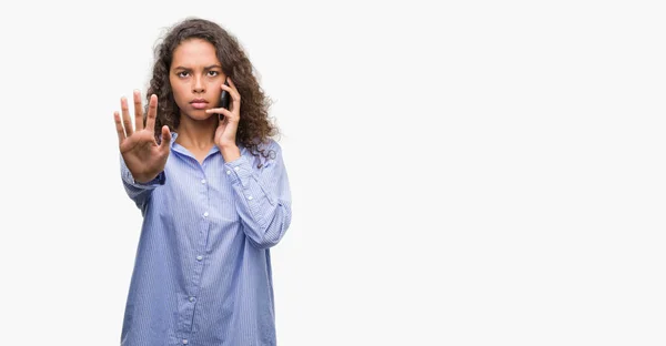 Young Hispanic Woman Using Smartphone Open Hand Doing Stop Sign — Stock Photo, Image