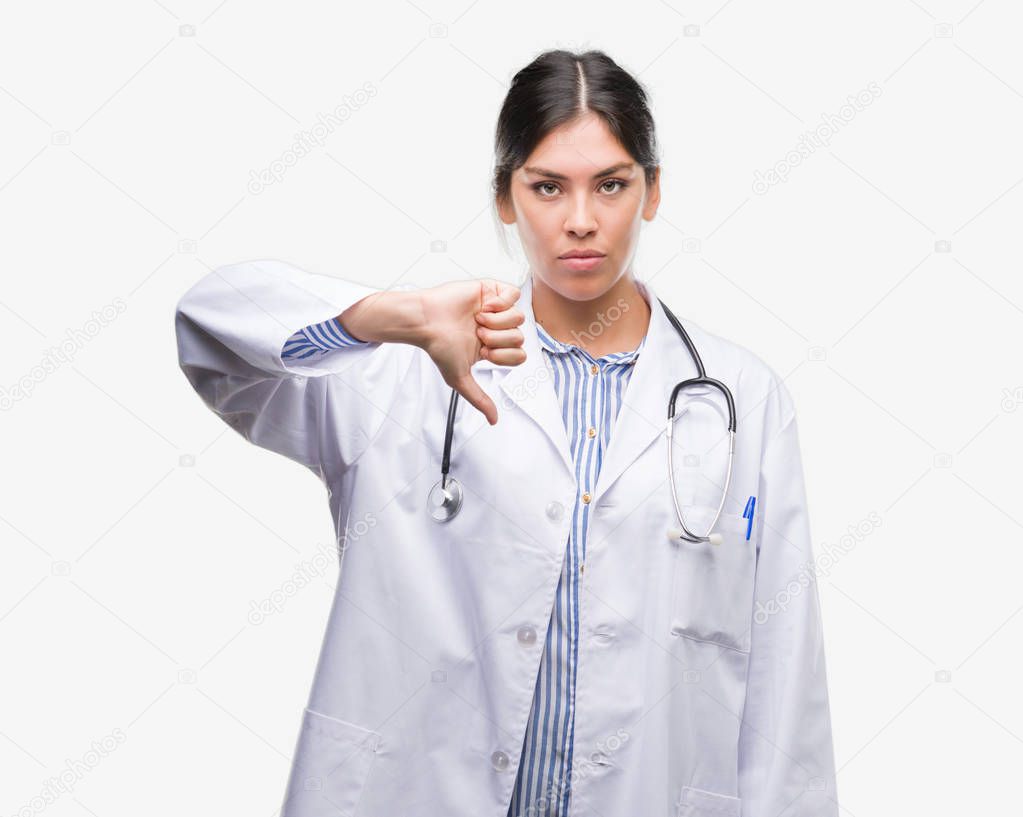 Young hispanic doctor woman with angry face, negative sign showing dislike with thumbs down, rejection concept