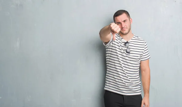 Homem Caucasiano Jovem Sobre Parede Grunge Cinza Olhando Infeliz Irritado — Fotografia de Stock