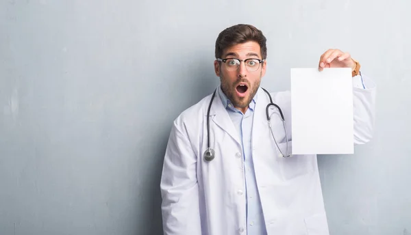 Handsome Young Doctor Man Grey Grunge Wall Holding Blank Sheet — Stock Photo, Image