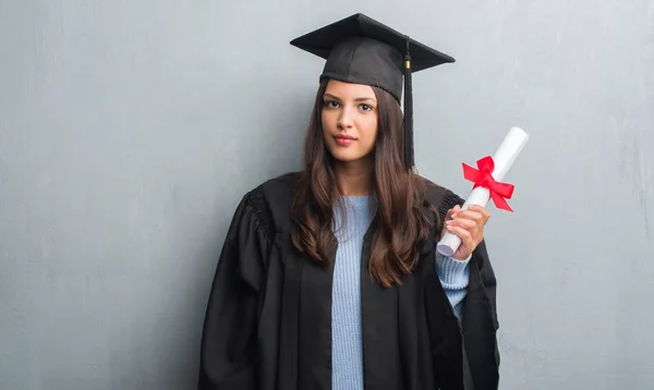 Young Brunette Woman Grunge Grey Wall Wearing Graduate Uniform Holding — Stock Photo, Image