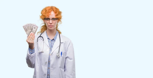 Young Redhead Doctor Woman Holding Dollars Confident Expression Smart Face — Stock Photo, Image