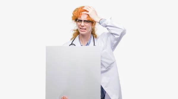 Young Redhead Doctor Woman Holding Banner Stressed Hand Head Shocked — Stock Photo, Image