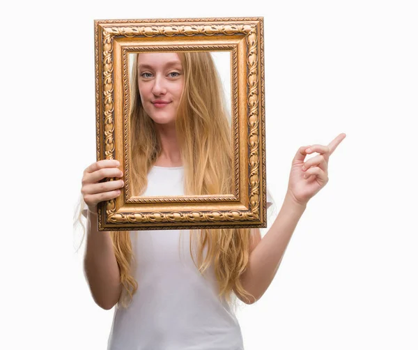 Blonde Teenager Woman Holding Vintage Frame Art Very Happy Pointing — Stock Photo, Image