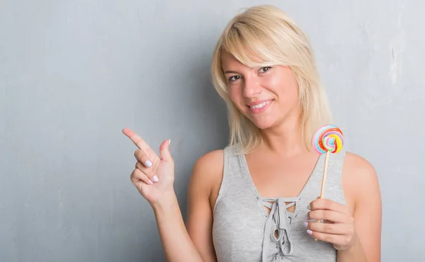 Caucasian Adult Woman Grey Grunge Wall Eating Candy Lollipop Very — Stock Photo, Image