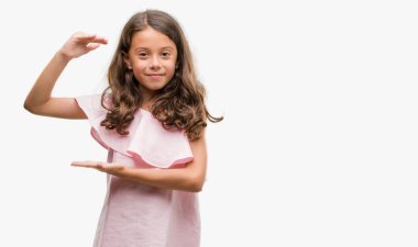 Pembe elbise ile büyük ve büyük boy işaret, ölçü birimi sembol gösteren el eller esmer İspanyol kız. Kameraya bakarak gülümsüyordu. Ölçüm kavramı.