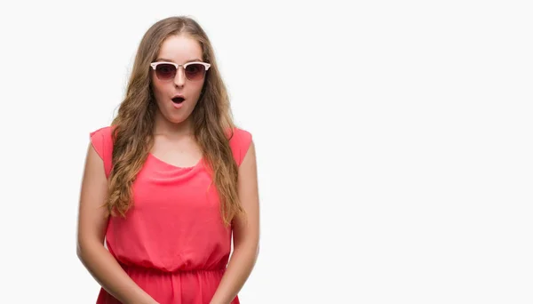 Young Blonde Woman Wearing Pink Sunglasses Scared Shock Surprise Face — Stock Photo, Image