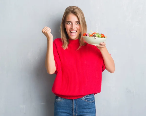 Mulher Bonita Sobre Grunge Parede Cinza Comendo Salada Tomate Gritando — Fotografia de Stock