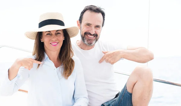 Middle Age Couple Traveling Sailboat Surprise Face Pointing Finger Himself — Stock Photo, Image