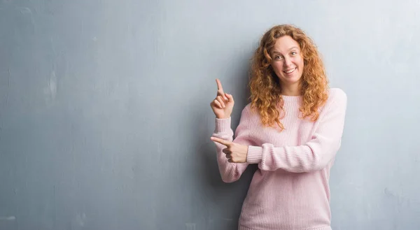 Junge Rothaarige Frau Über Grauer Grunge Wand Rosa Pullover Lächelnd — Stockfoto