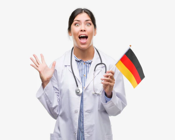 Joven Doctora Hispana Sosteniendo Bandera Alemania Muy Feliz Emocionada Expresión —  Fotos de Stock