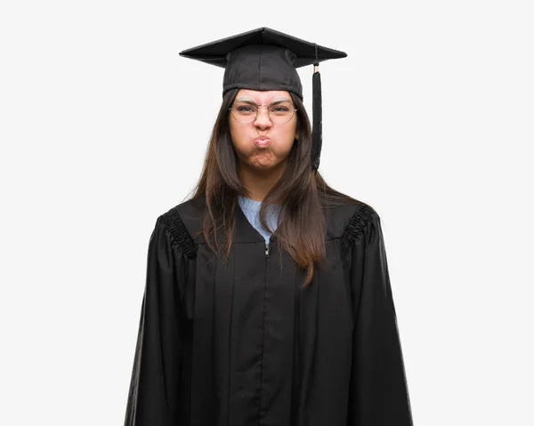 Young Hispanic Woman Wearing Graduated Cap Uniform Puffing Cheeks Funny — Stock Photo, Image