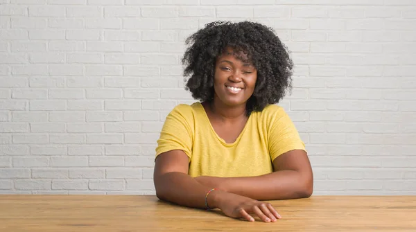 Unga Afroamerikanska Kvinnan Sitter Bord Hemma Winking Tittar Kameran Med — Stockfoto