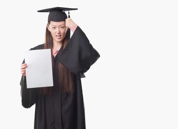 Young Chinese Woman Wearing Graduate Uniform Holding Paper Degree Annoyed — Stock Photo, Image