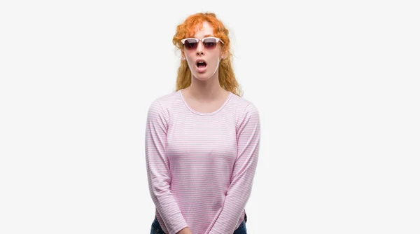 Young Redhead Woman Wearing Sunglasses Scared Shock Surprise Face Afraid — Stock Photo, Image