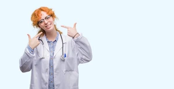 Young Redhead Woman Wearing Doctor Uniform Smiling Confident Showing Pointing — Stock Photo, Image