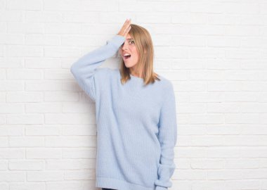 Güzel genç kadın beyaz tuğla duvar başında hata için el ile sürpriz yüzünden hata hatırlıyorum. Unuttum, kötü bellek kavramı.