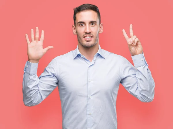 Handsome Young Businessman Showing Pointing Fingers Number Seven While Smiling — Stock Photo, Image