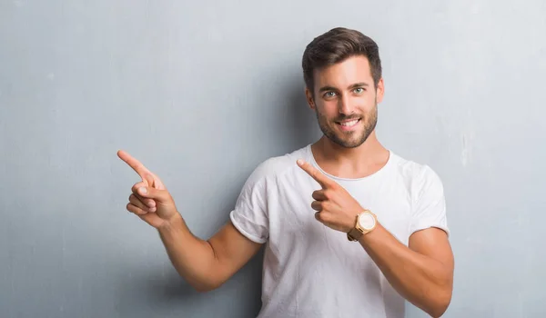 Handsome Young Man Grey Grunge Wall Smiling Looking Camera Pointing — Stock Photo, Image