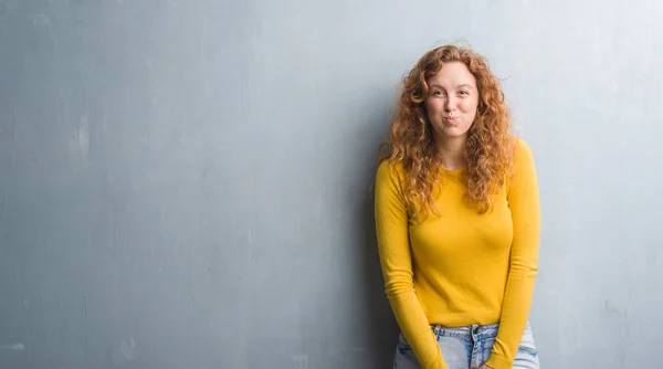 Mujer Pelirroja Joven Sobre Gris Grunge Pared Hinchando Mejillas Con — Foto de Stock