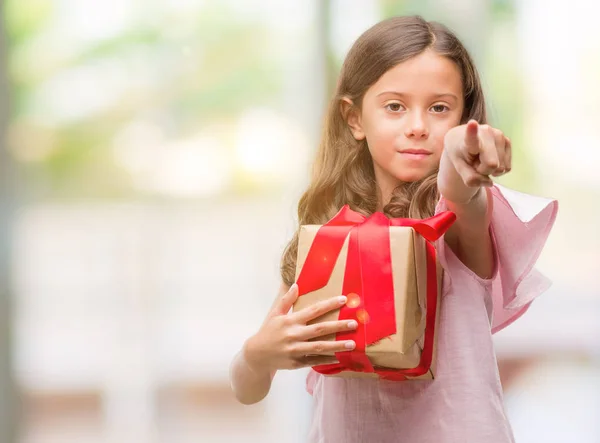 Brunette Hispanic Girl Holding Gift Pointing Finger Camera You Hand — Stock Photo, Image