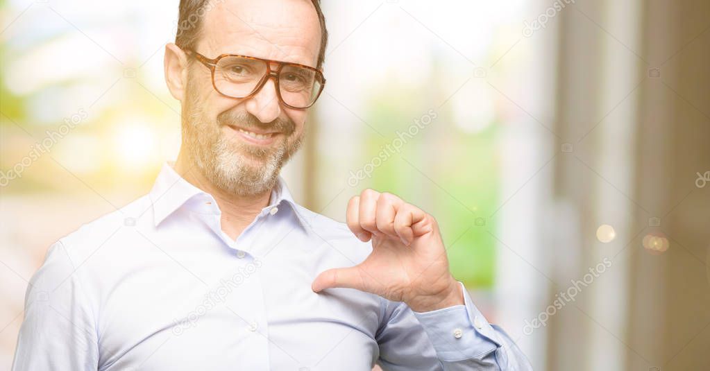 Middle age man with glasses proud, excited and arrogant, pointing with victory face