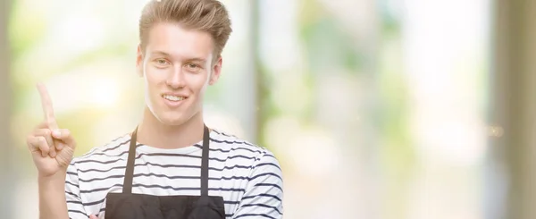 Ung Snygg Blond Man Iklädd Förkläde Mycket Glad Pekar Med — Stockfoto