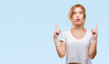 Genç güzel kadın izole arka plan üzerinden hayran ve yukarıya bakıp parmakları ile işaret şaşırttı ve silah kaldırdı.