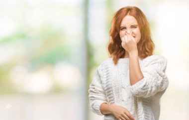 İzole arka plan bir şey pis ve iğrenç kokulu kış kazak, dayanılmaz koku, holding nefes parmak ile burun üzerinde giyen genç güzel kadın. Kötü kokuyor kavramı.