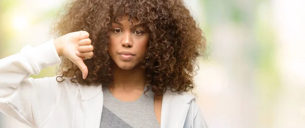 African american fitness woman training with angry face, negative sign showing dislike with thumbs down, rejection concept