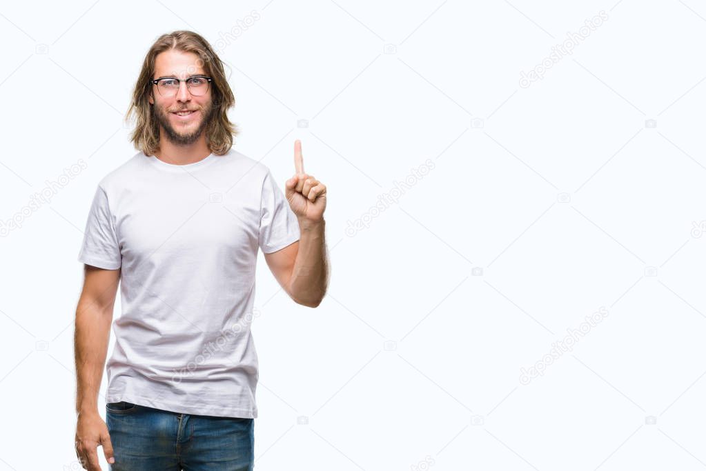 Young handsome man with long hair wearing glasses over isolated background showing and pointing up with finger number one while smiling confident and happy.