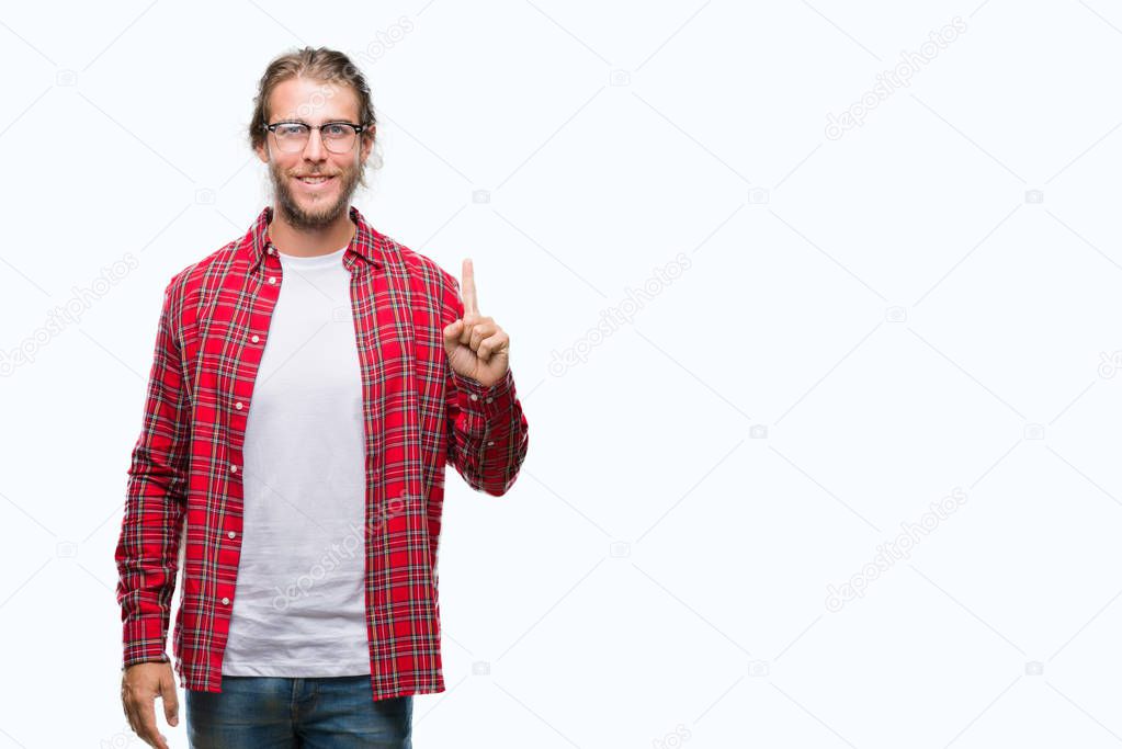 Young handsome man with long hair wearing glasses over isolated background showing and pointing up with finger number one while smiling confident and happy.